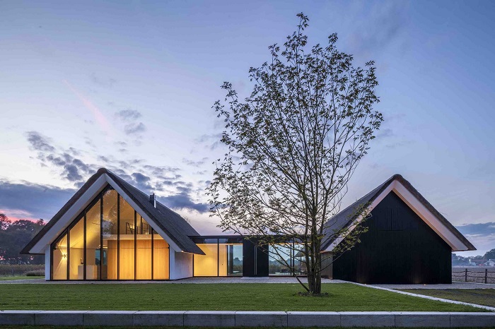 Dutch Firm Combines Greenhouse and Thatched Cottage in Country Villa